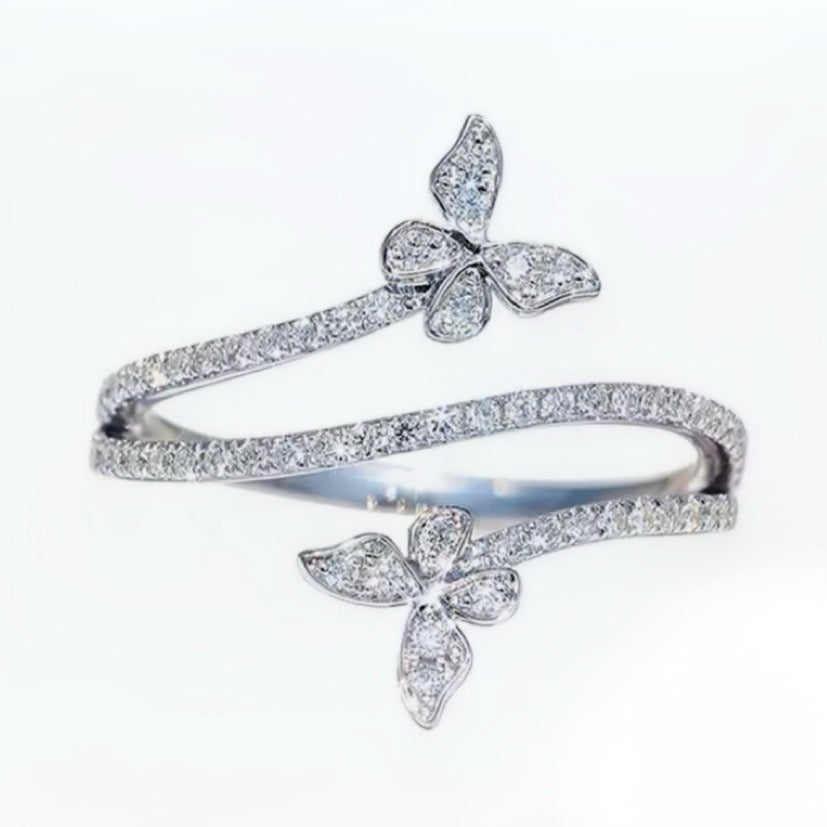 Silver ring with butterfly design on a white background
