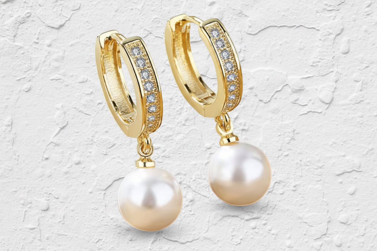 Gold huggie earrings with diamantè style finish and drop round white pearls.