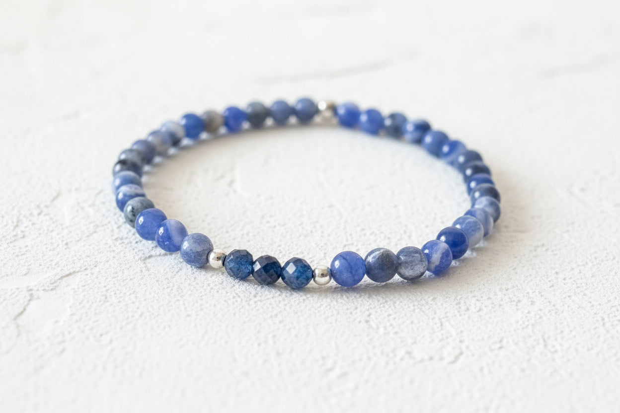 Blue beaded bracelet on a textured surface.
