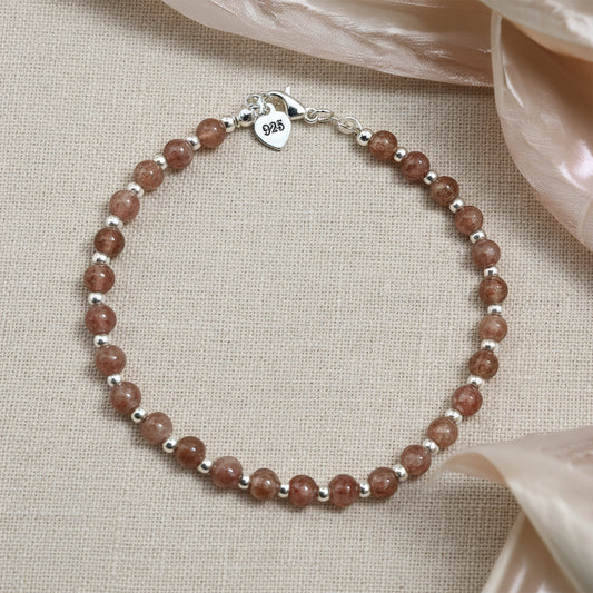A strawberry quartz and 925 beaded bracelet with silver beads.