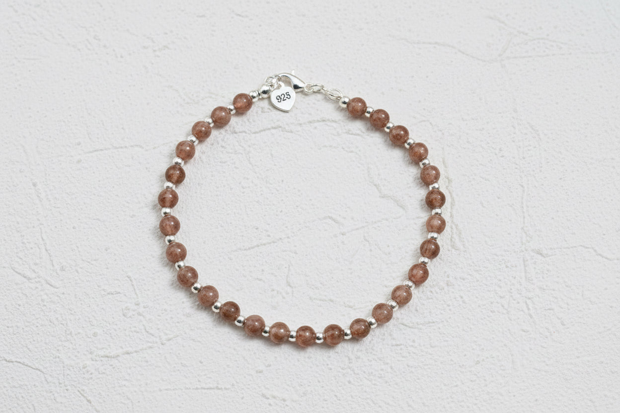 A strawberry quartz and 925 beaded bracelet with silver beads.
