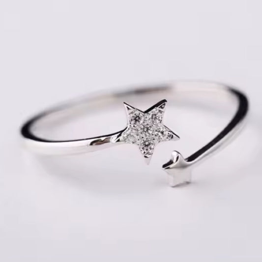 Silver ring with two stars on a white background