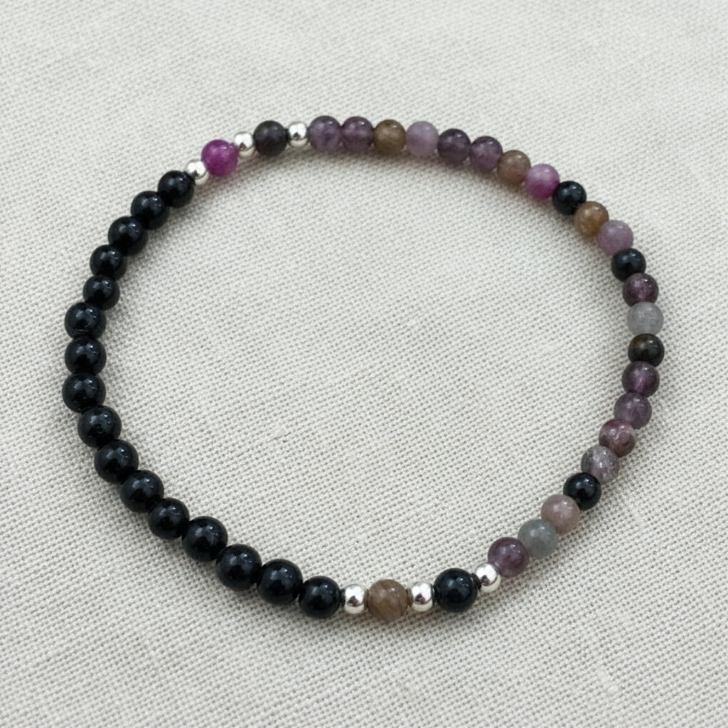 Beaded bracelet with black, purple, and silver beads.