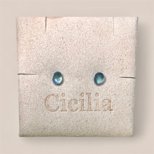 Pair of blue sea glass earrings on a Cicilia branded jewellery display card.