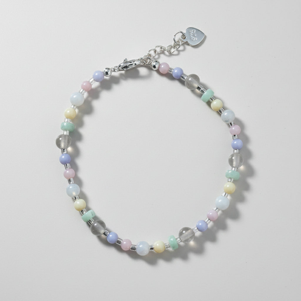 Beaded bracelet with a silver clasp made up of pastel and clear coloured beads.