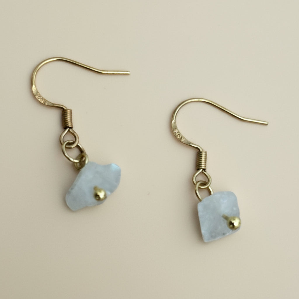 Raw moonstone earrings on gold hooks.