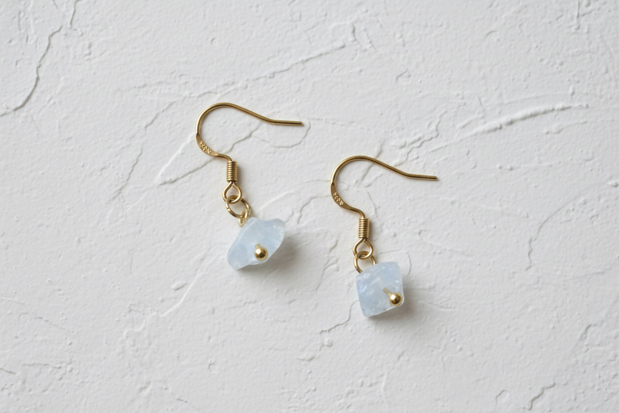 Raw moonstone earrings on gold hooks.
