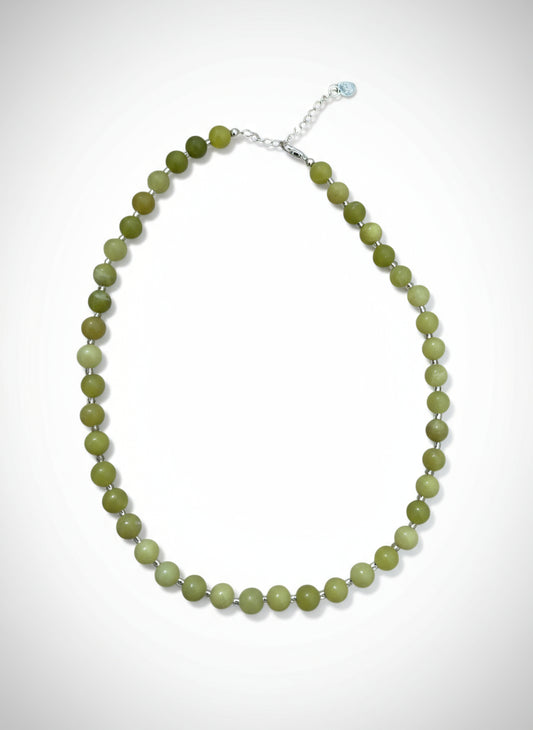 Necklace with green beads on a white background.