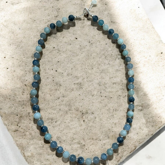 Beaded necklace with blue beads in alternating shades.
