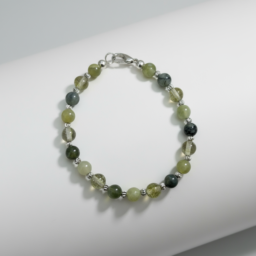 Beaded bracelet with green and black beads on a white background.