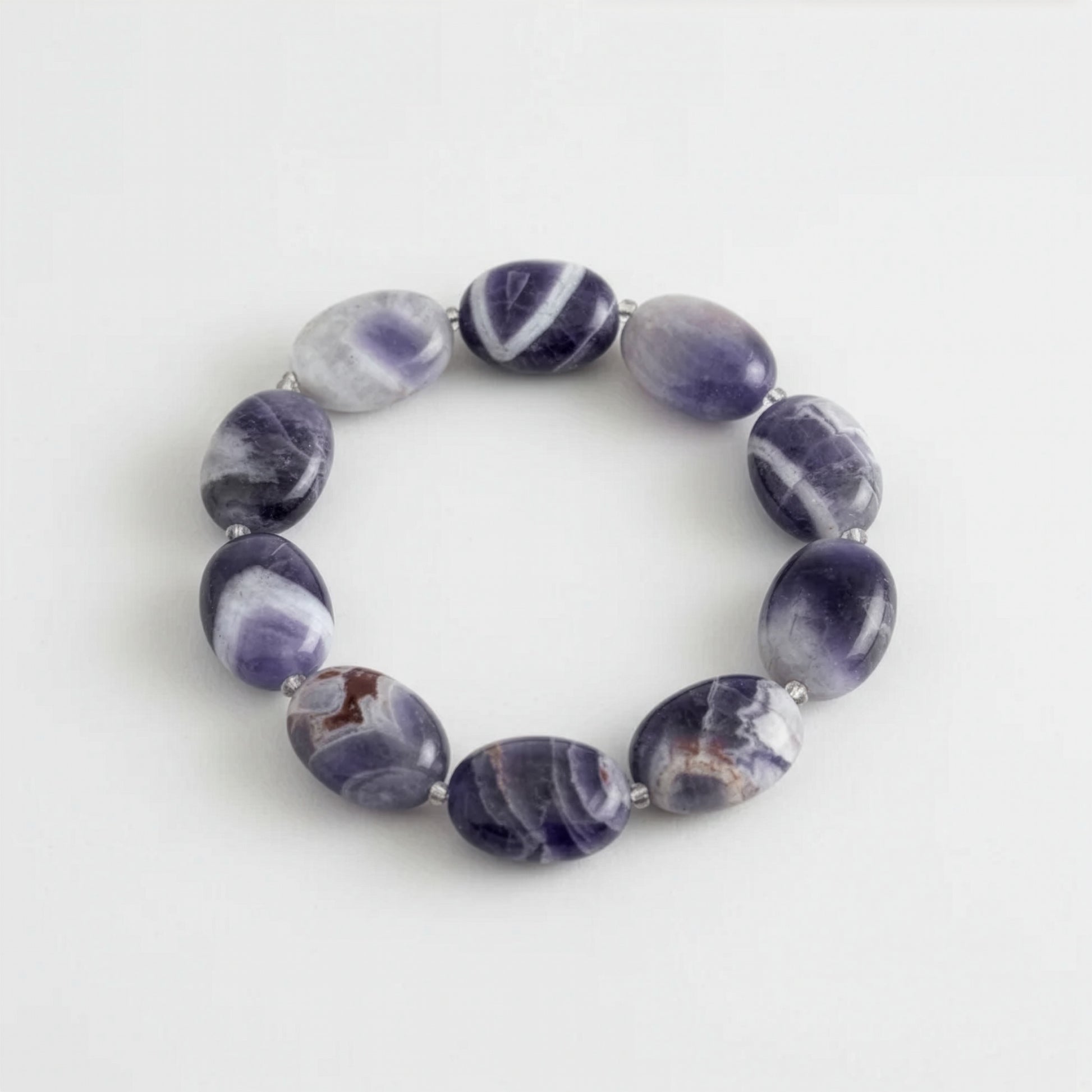 Purple amethyst beaded bracelet on a light grey background.