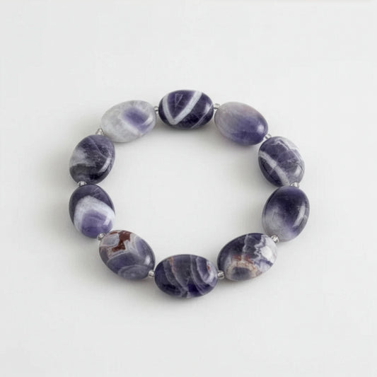 Purple amethyst beaded bracelet on a light grey background.