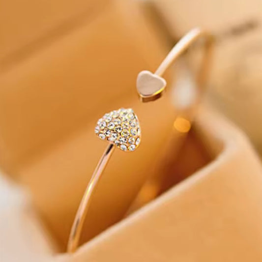 Gold bracelet with two hearts