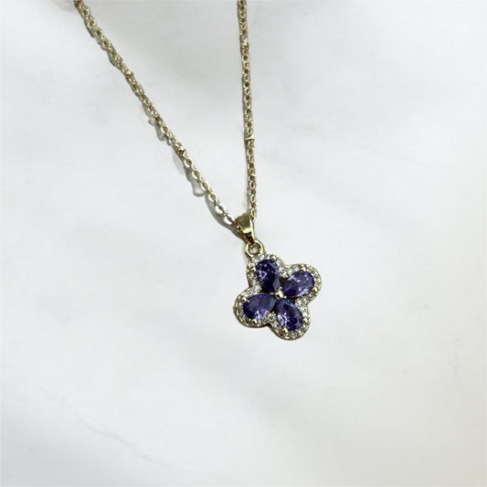 Necklace with a floral pendant featuring purple stones on a white background