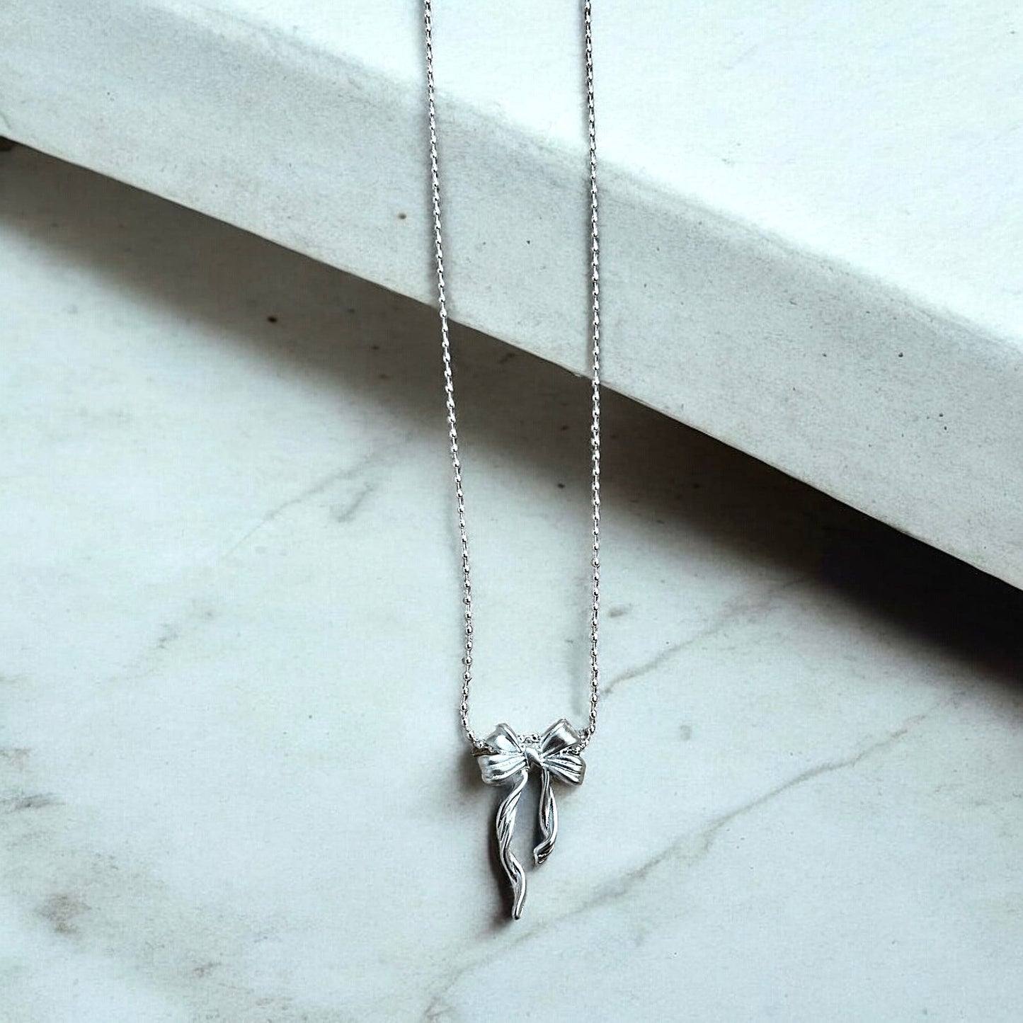 Sterling silver bow necklace
