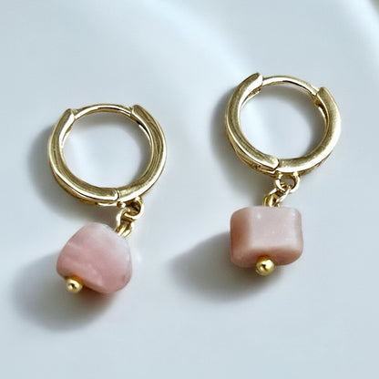 Raw pink opal gemstone earrings on gold huggies.