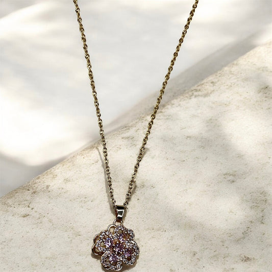 Necklace with a floral pendant.
