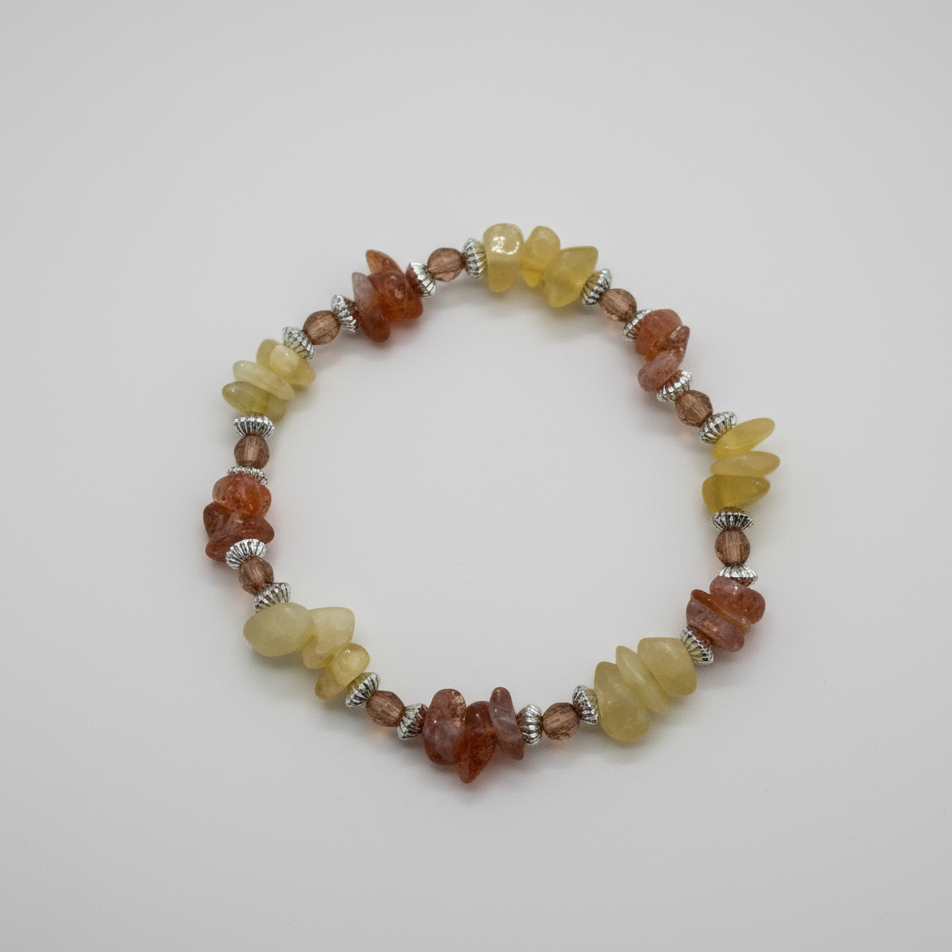 Honey yellow calcite & sunstone orange crystal chip bracelet on neutral studio background.