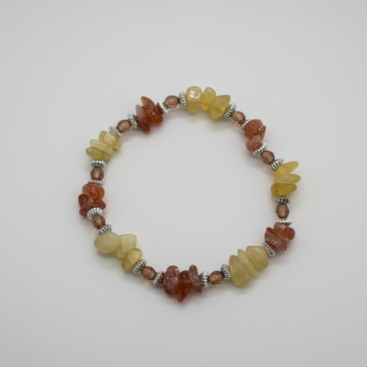Honey yellow calcite & sunstone orange crystal chip bracelet on neutral studio background.