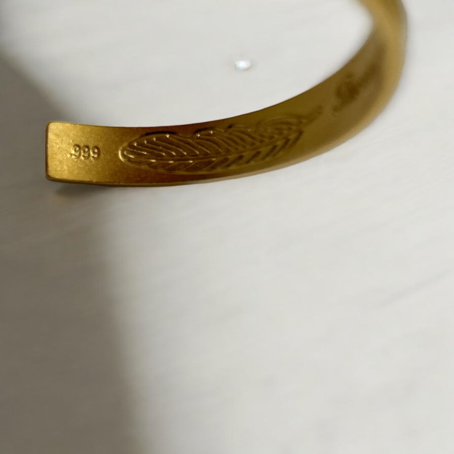 Sand gold feather bangle with inscription