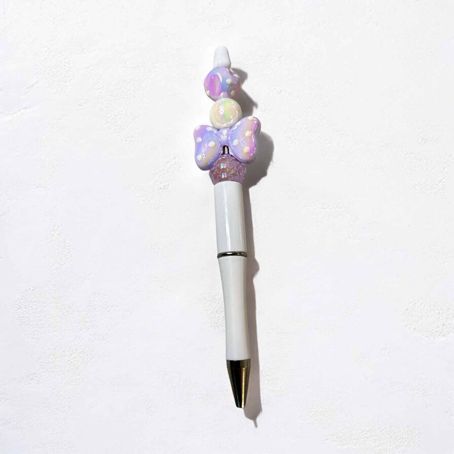 White and purple bow spotty pen
