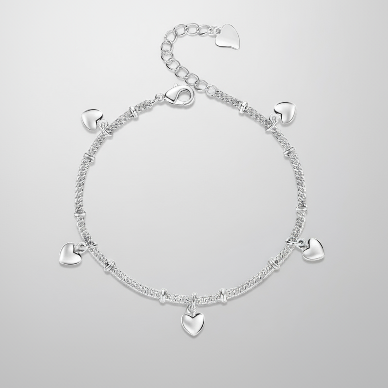 Silver bracelet with heart charms on a light grey background.