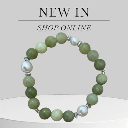 Beaded bracelet with green and white beads on a light grey background and the text 'New In and Shop Online.'