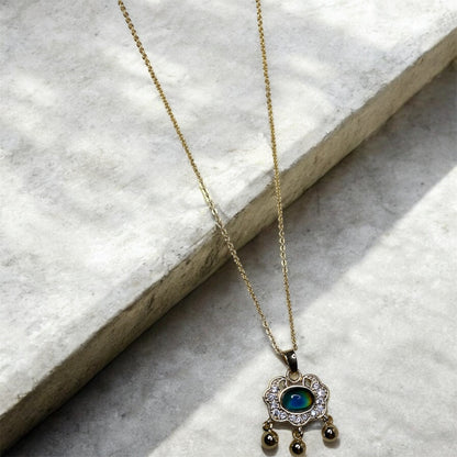Gold necklace with colour change pendant