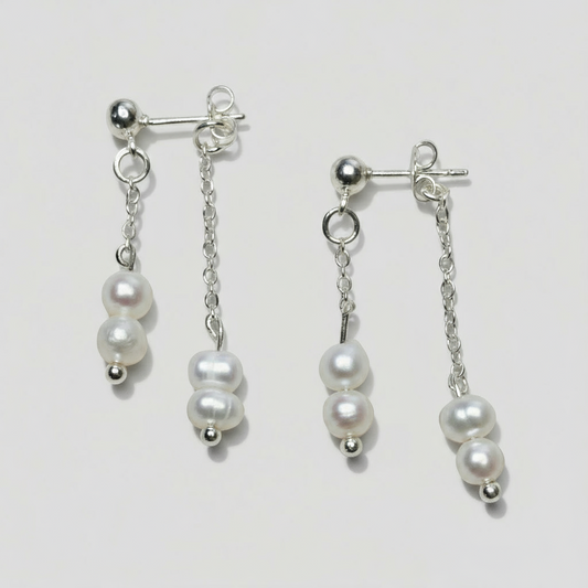 Pair of pearl earrings on a light background