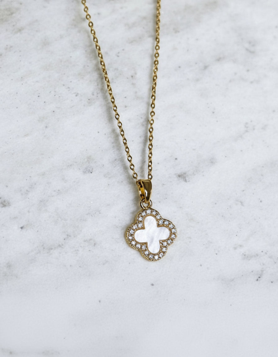 Mother of pearl pendant necklace on a gold coloured chain.