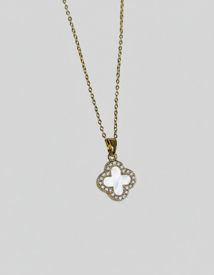 Necklace with a clover-shaped pendant on a light grey background.